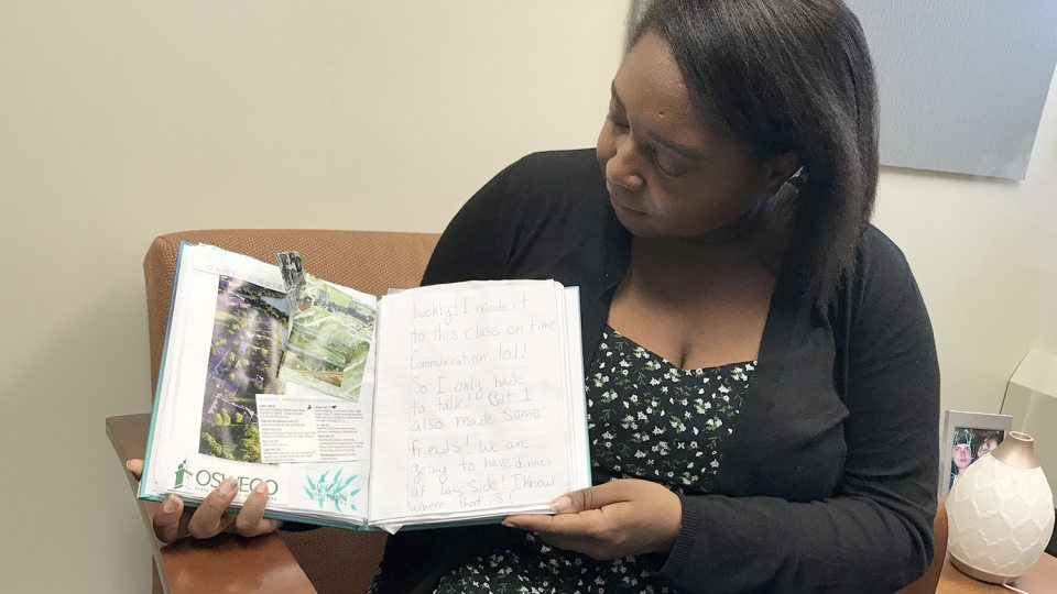 Oreal Vernon holds a book that is a resource for educators on dyslexic students