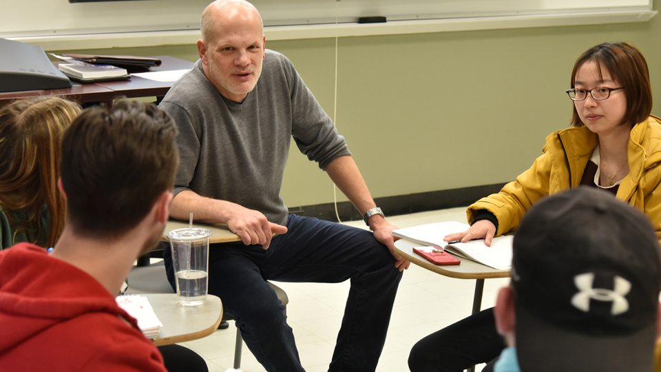 Economics professor David Andrews having class discussion
