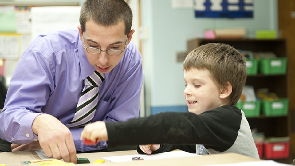 Oswego student teaching in a children's classroom with student