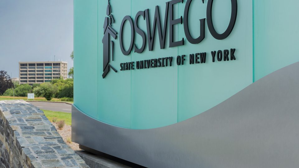 Oswego sign at college entrance
