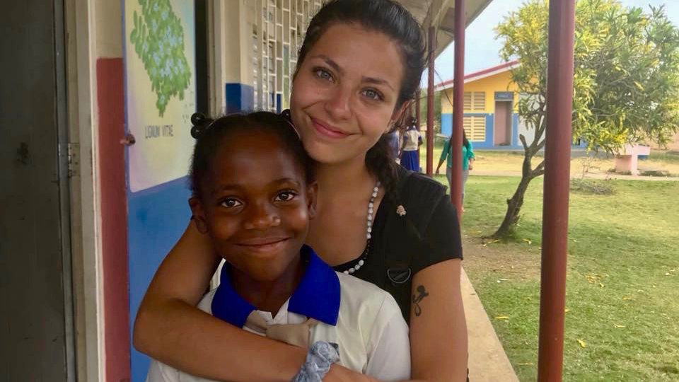 Isabella Falcigno hugs a Jamaican youth