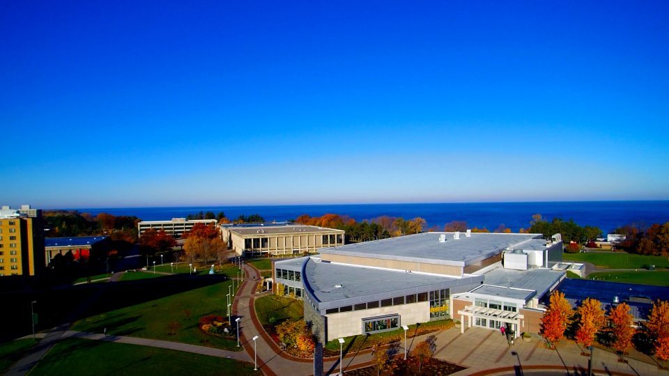 Aerial view of campus with fall foliage and Lake Ontario