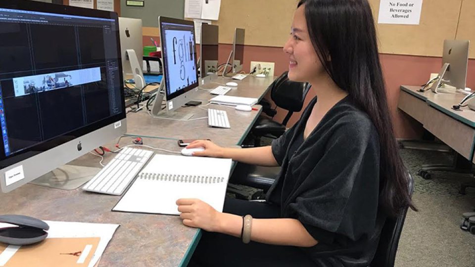 Jingyuan Duan works on her art via computer