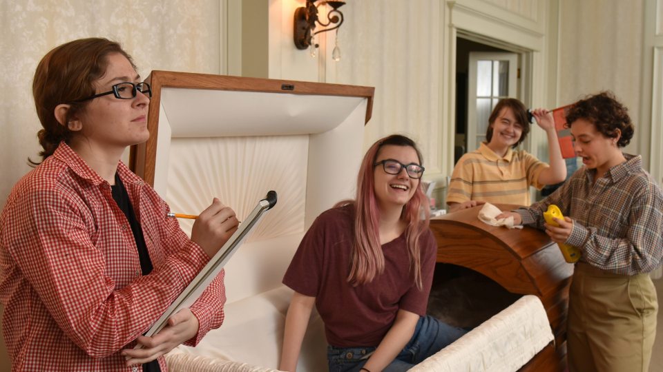 Cast photo of actors playing children filming a funeral home ad