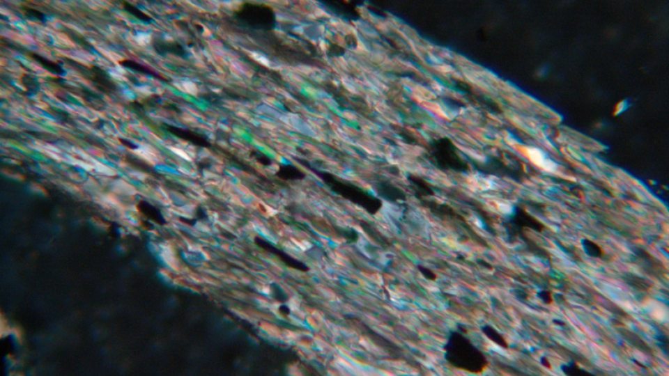 A rock photo was taken by David Valentio using a microscope. The field of view is about 5 millimeters