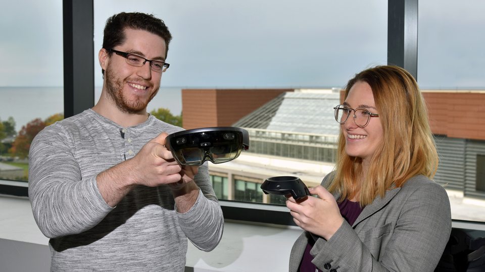 Human-computer interaction students Theo Johnson and Anne Reynolds look over a holographic computer