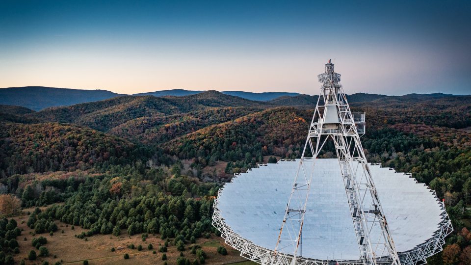 The massive Green Bank Telescope points to the sky, picking up observations in part of a cosmic puzzle researchers try to solve