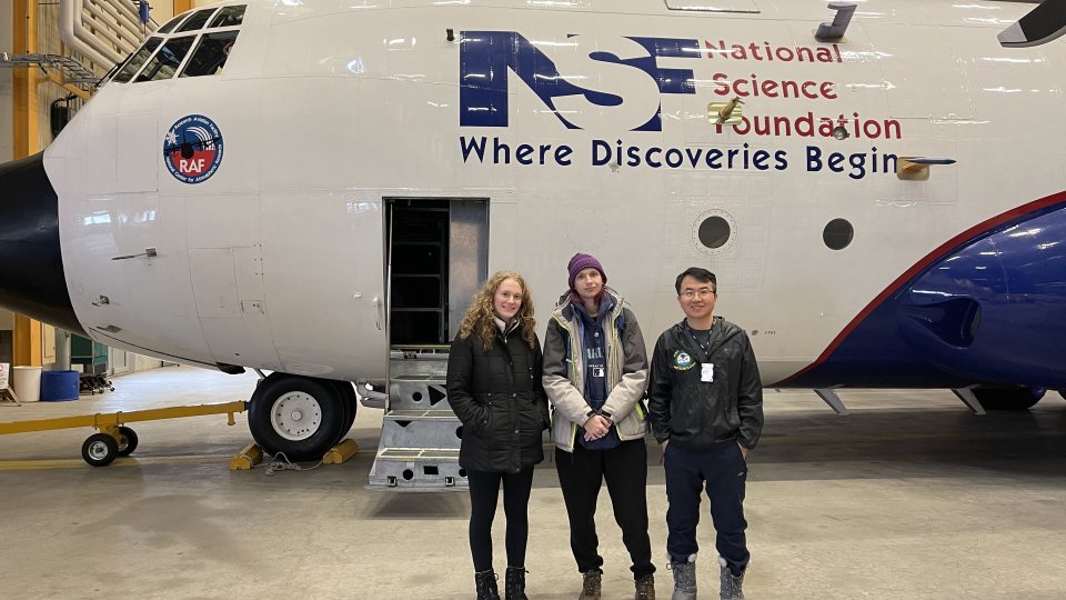 Oswego students Sarah Gryskewicz and Bee Lamsma, and Dr. Yonggang Wang stand in front of the NCAR C-130 research aircraft.