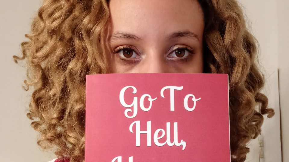 Heaven Santiago with her book of poetry, Go To Hell, Heaven
