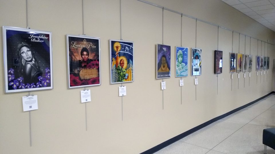 A row of portraits of notable women lines the wall of Penfield Library