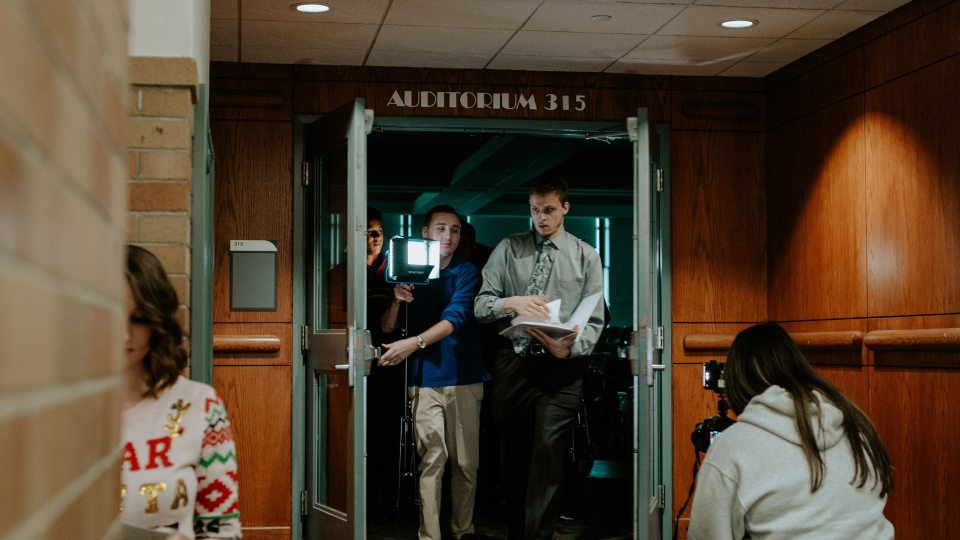 Students making holiday TV special come out of Park Hall auditorium