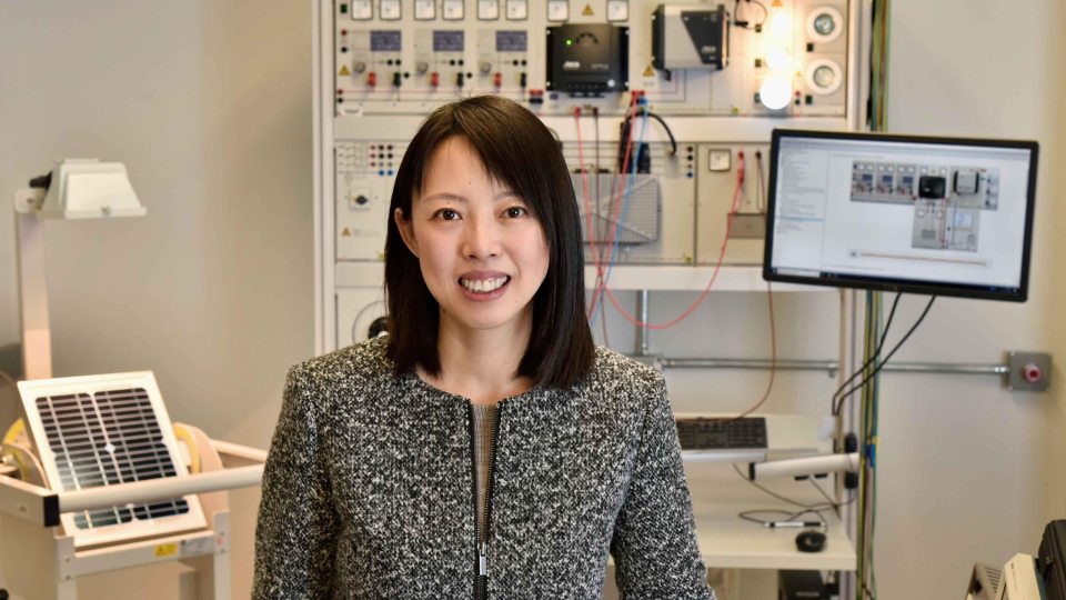 Professor Hui Zhang in lab with computer science and engineering equipment