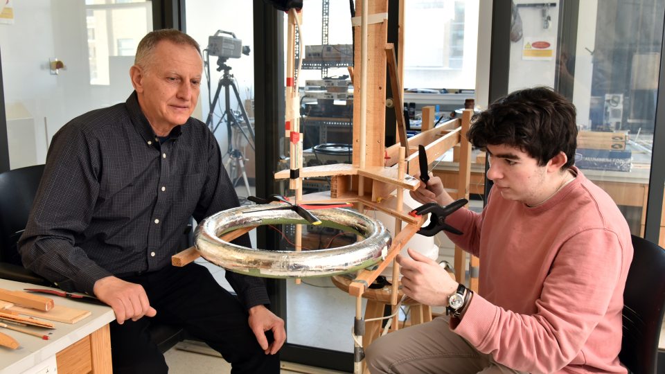 Electrical and computer engineering faculty member Adrian Ieta and a student research assistant work in a Shineman Center lab