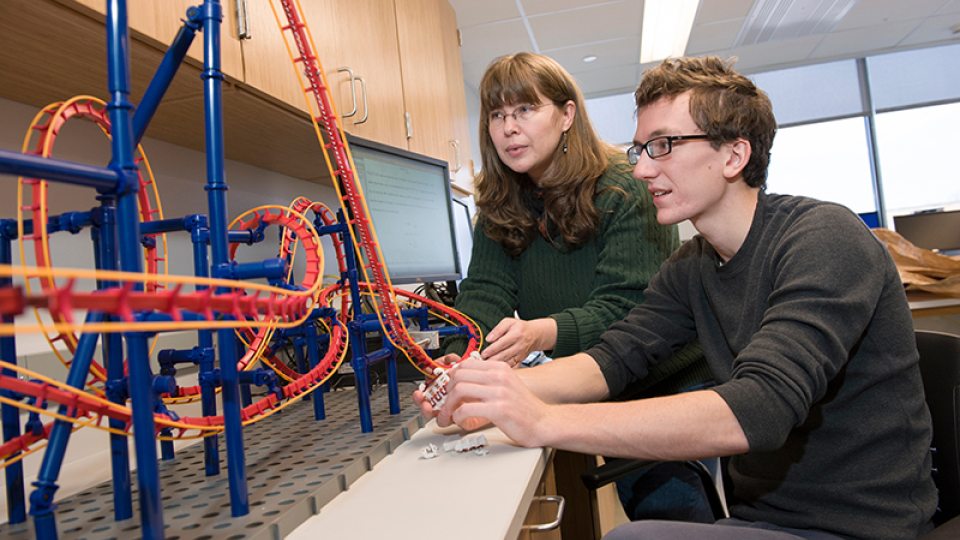 Professor Carolina Ilie and student working on physics of rollercoasters project
