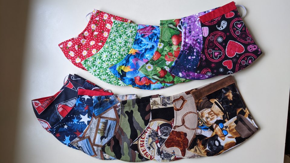 Variety of colorful face masks that are among 450 Candy Rasbeck has made
