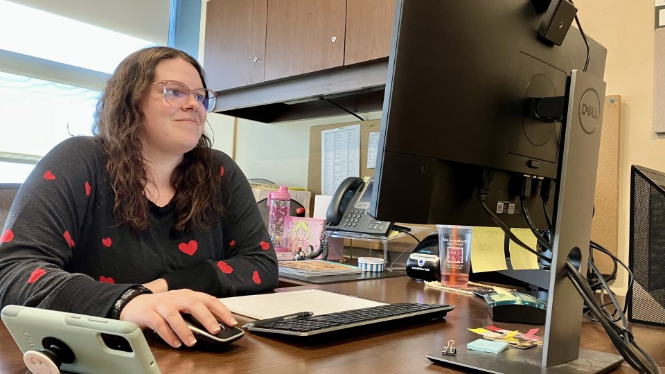 Amy Wallace works on a computer on campus