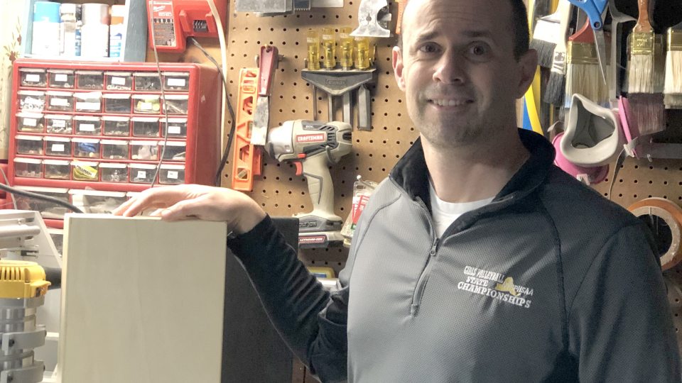 Jeff Evans, in his workshop space, shows off the wiNest, a patented idea that advanced to a statewide student business plan competition