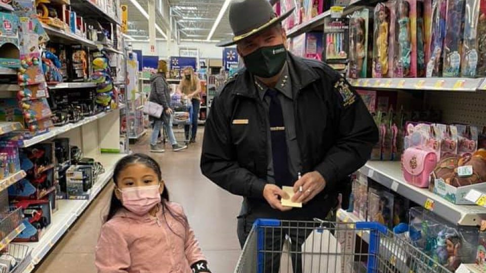 University Police Chief Kevin Velzy helps young shopper Karla find presents for her family during Shop With a Hero