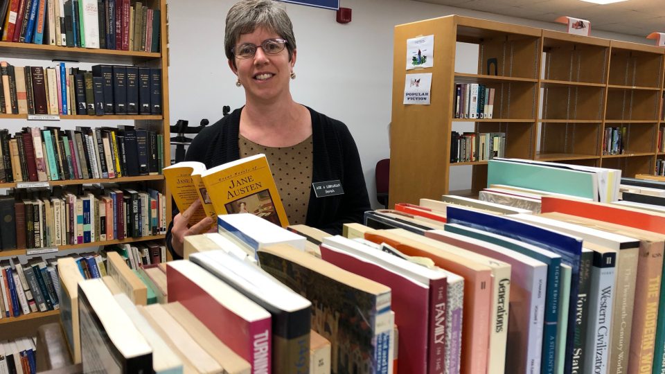 Sarah Weisman looks at books for Penfield Library book sale