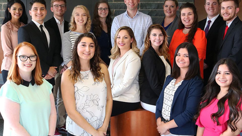 Group shot of students who organize Media Summit with adviser Michael Riecke