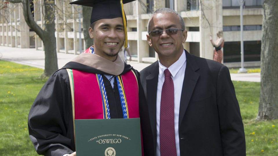 Carlos Minaya celebrates his master's degree with his father