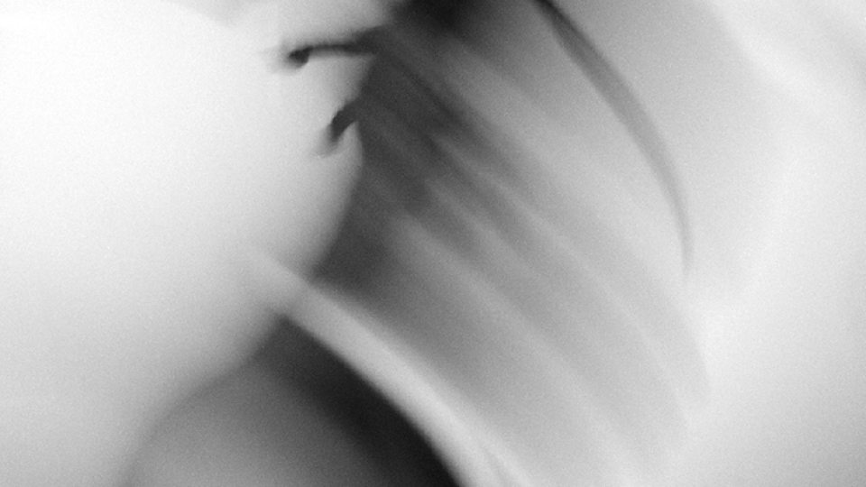 Black and white photo titled Drowning by Liam Morgenstern shows a blurred figure on a white background