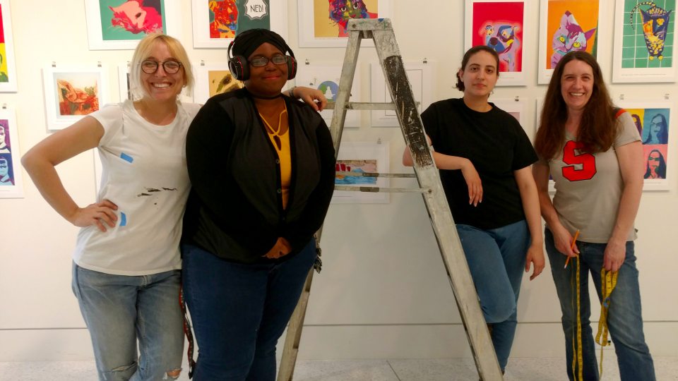 College students prep, hang variety of artwork by schoolchildren in gallery