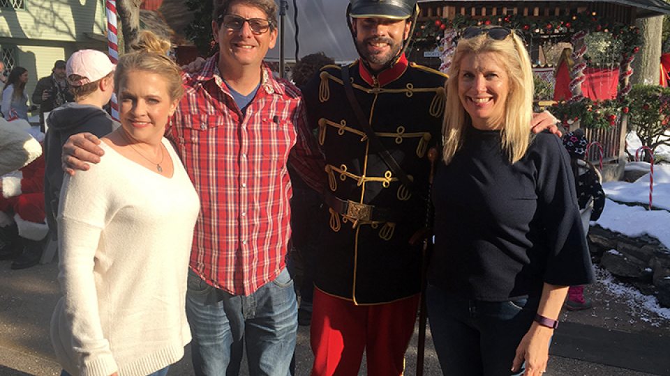 Faculty member Juliet Giglio poses with co-writing husband and stars from A Very Nutty Christmas