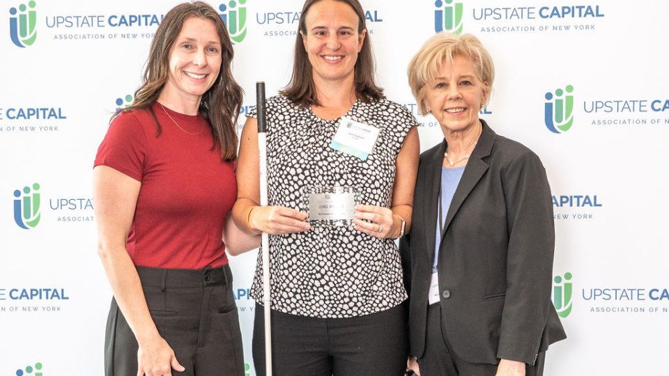 Erin Czadzeck (center), a student in Oswego's online MBA program, is honored for placing second in her division in the New York State Business Plan competition, flanked by Sarah Bonzo (left) and Irene Scruton