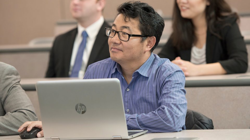 Students with laptops in a classroom