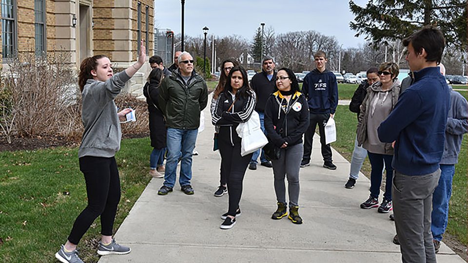 Student leads admission tour for families