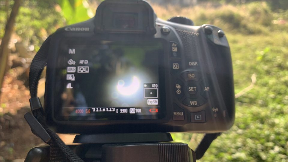 View of a solar eclipse through a viewfinder -- courtesy of Delse Pauly DM under a Creative Commons license