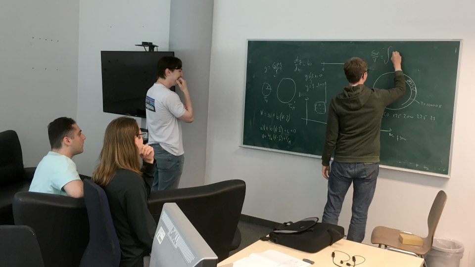 SUNY Oswego students (from left) Michele Manno, Hugh Riley Randall and Selim Kalici attend a lecture from Oswego alumnus Earl Bellinger, who is now a postdoctoral research fellow at the world-renowned Max Planck Institute for Astrophysics in Germany