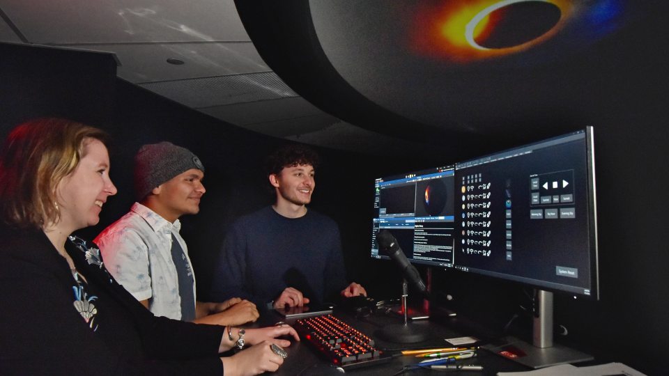 From left, SUNY Oswego planetarium director Natalia Lewandowska speaks with students Jason Ruiz and Stephen Miskovsky about putting together planetarium shows.