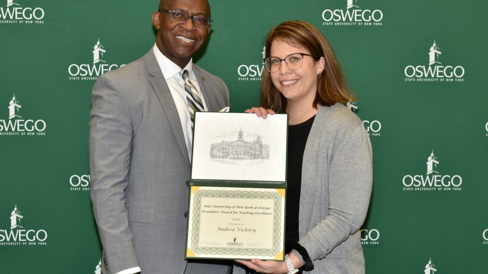 President Peter O. Nwosu presents the President's Award for Teaching Excellence to communication studies faculty member Andrea Vickery