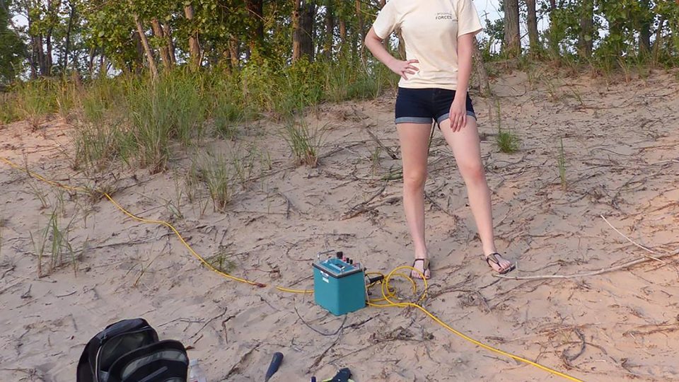 Kimberly Smith doing research on dunes by Lake Ontario