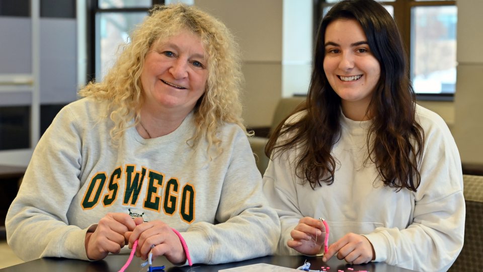 Val Mayer and Jackie Gamlen working with the beads they used at the Destiny Center, creating meaningful moments with the children.