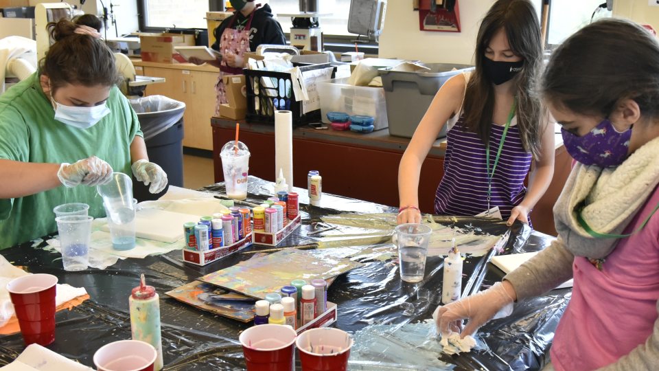 Children work with paint during a previous year's Sheldon Institute