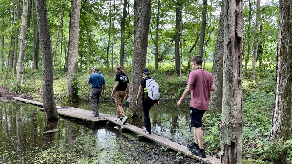 alking a trail are, from left, Jim D'Angelo, director of Sterling Nature Center, with student filmmakers Wells Liscomb and Lauren Smith (both seniors) and Ryan King (who graduated in 2023).