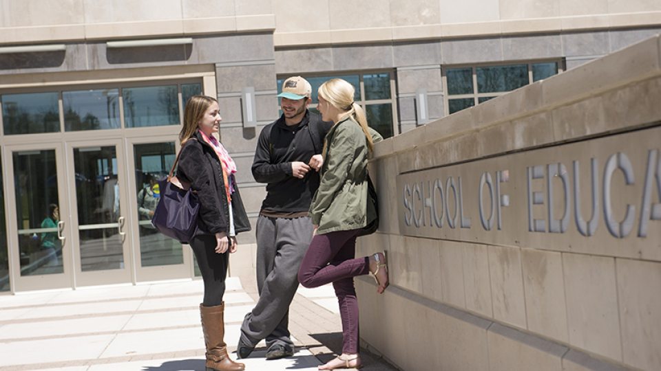 Students standing outside of the School of Education building