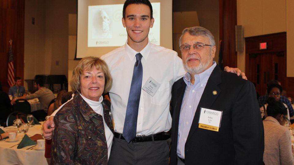 Srokas presenting scholarship to Oswego student