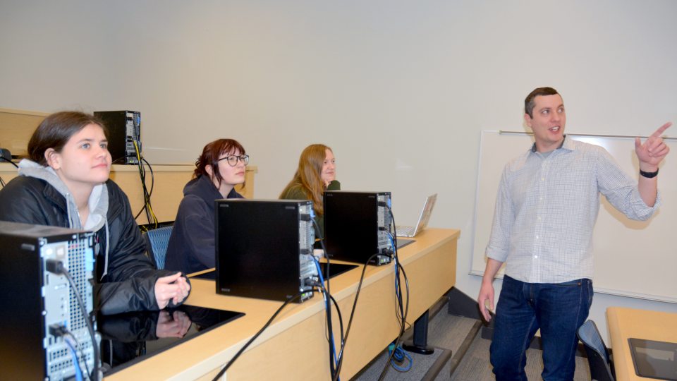 Mark Baker speaks to students in a statistics class
