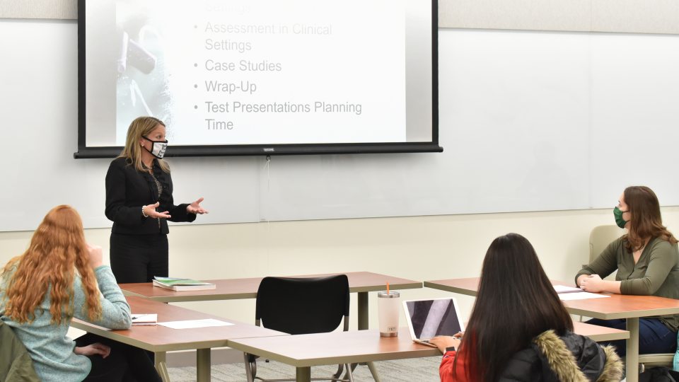 Michelle Storie of the counseling and psychological services faculty teaches a class in Wilber Hall