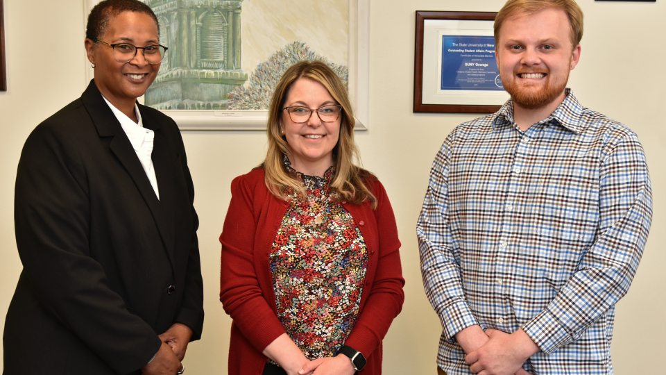 Three student affairs professionals gather in recognition of statewide awards