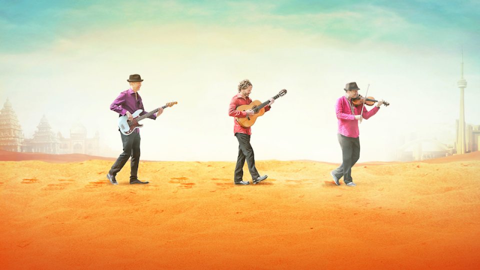 Three members of the Sultans of Swing musical ensemble walk across a colorful landscape holding instruments