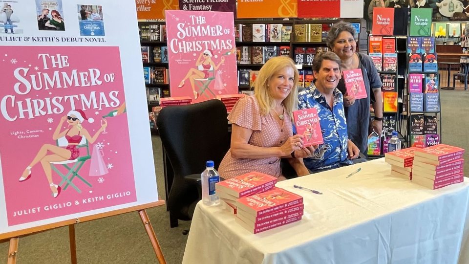 SUNY Oswego faculty member Juliet Giglio and her husband Keith, a Syracuse University faculty member, teamed up to write a new novel, "The Summer of Christmas"; here they participate in a book signing