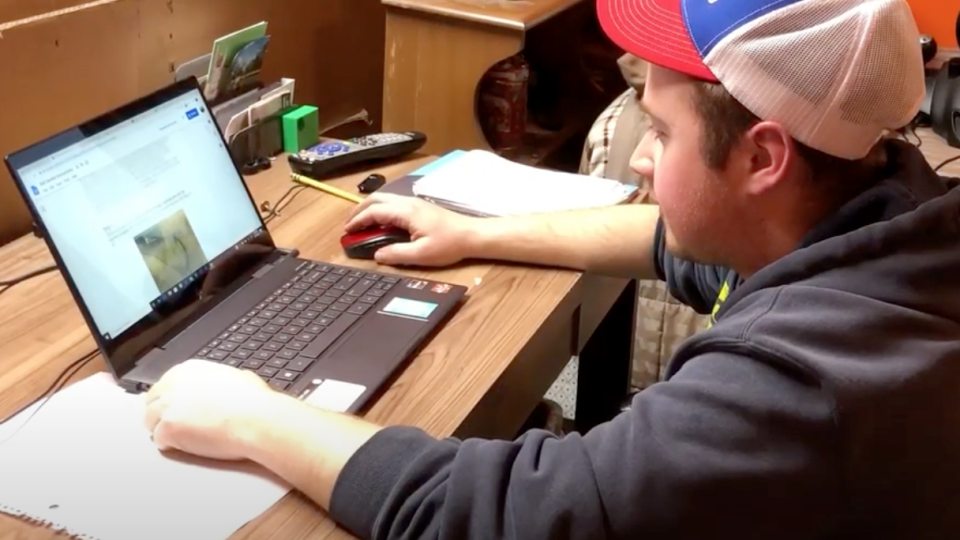 Corey Sykes demonstrates a home work station in a video about avoiding distractions