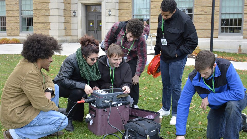 Students unpack a seismograph system