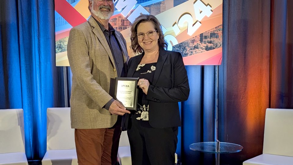 SUNY Oswego staff members accept UPCEA award