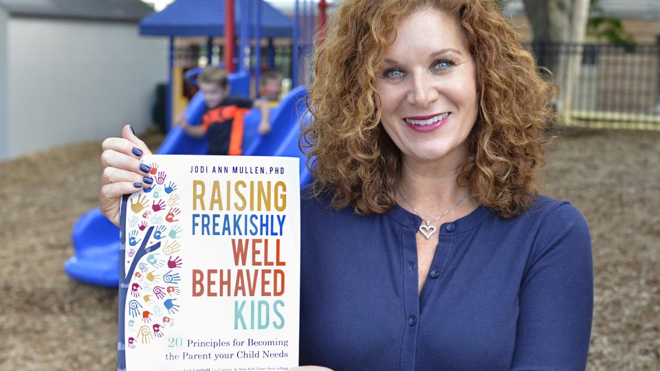Jodi Mullen with her book, Raising Freakishly Well Behaved Kids: 20 Principles for Becoming the Parent Your Child Needs